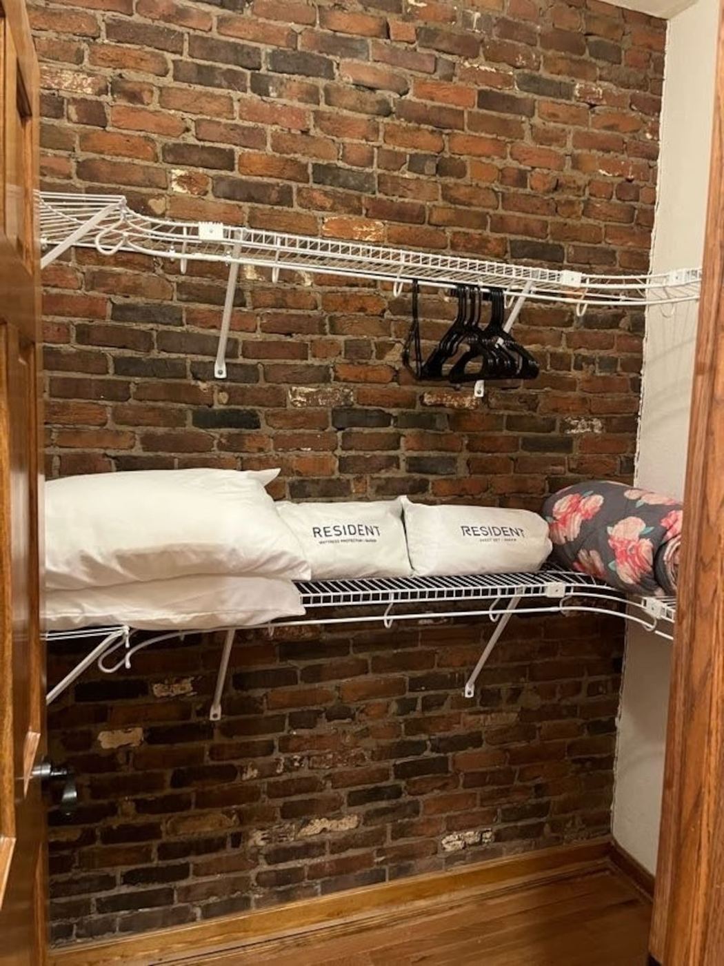 Closet with extra pillows, linens, and hangers