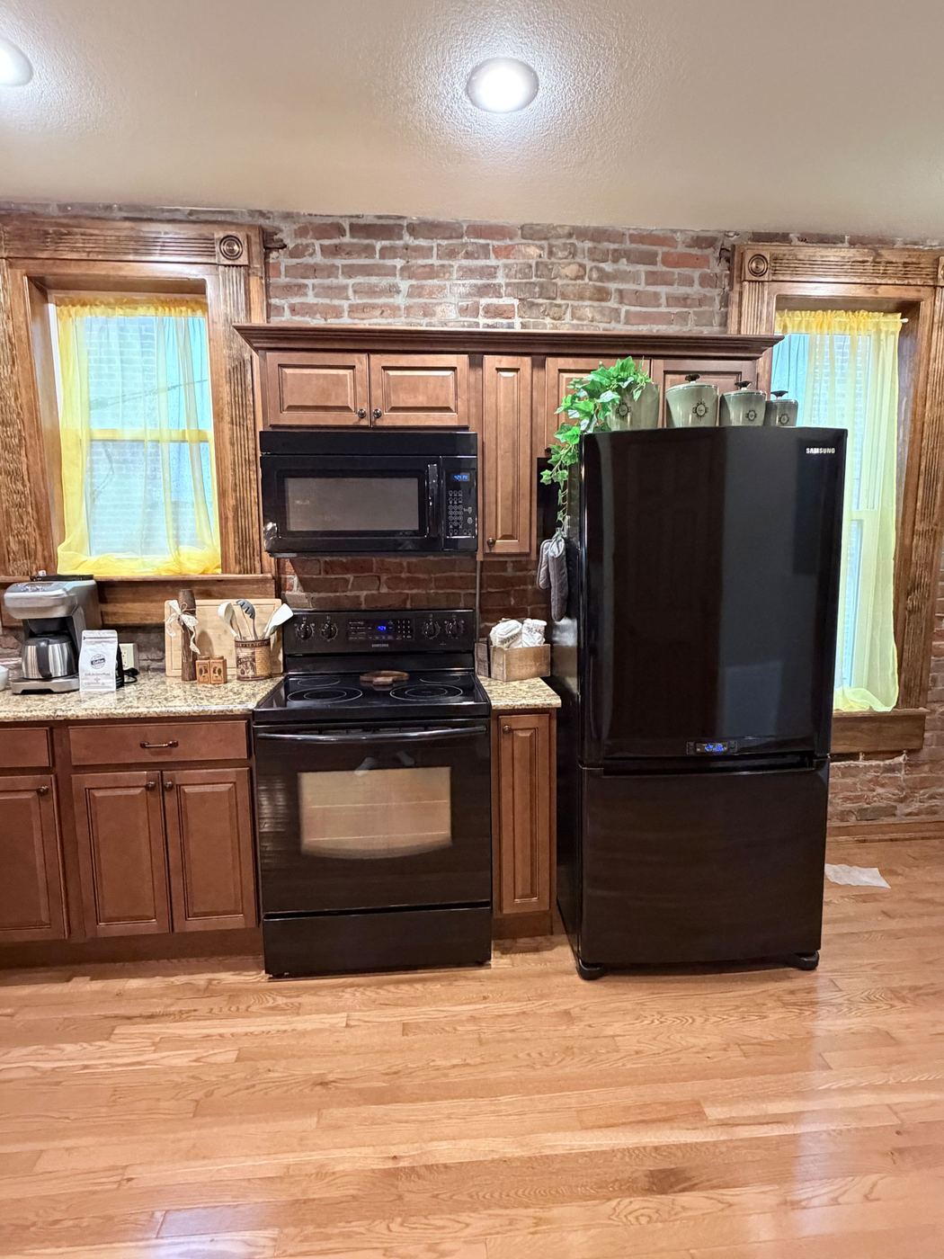 Kitchen with full-size appliances, coffee maker, and warm wood cabinets
