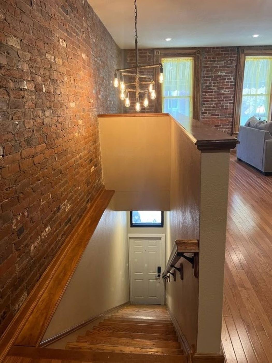 Staircase up to the apartment with an industrial chandelier